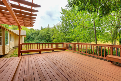 large wooden deck behind house